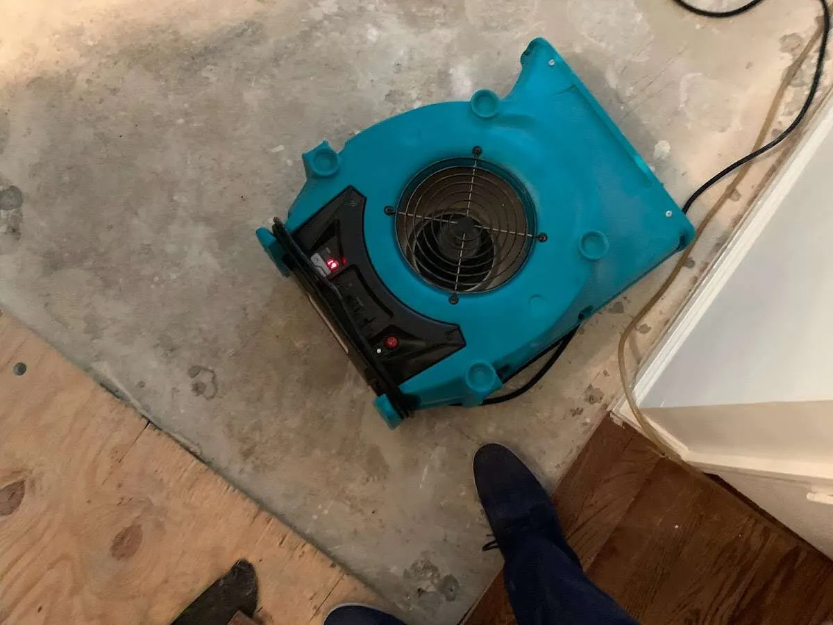 Air mover drying subfloor during Leak Detection & Repair in North Berwick